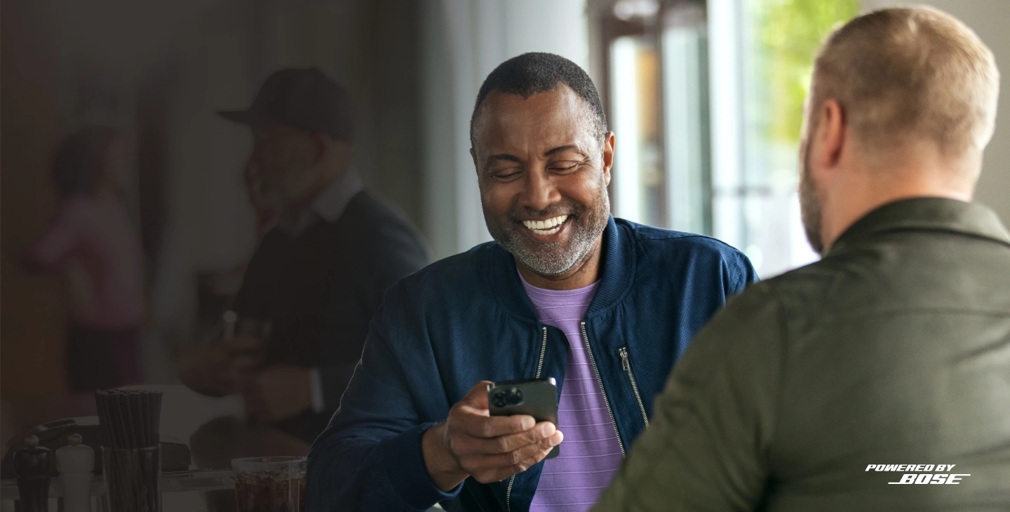 Two men smiling while using the Lexie app