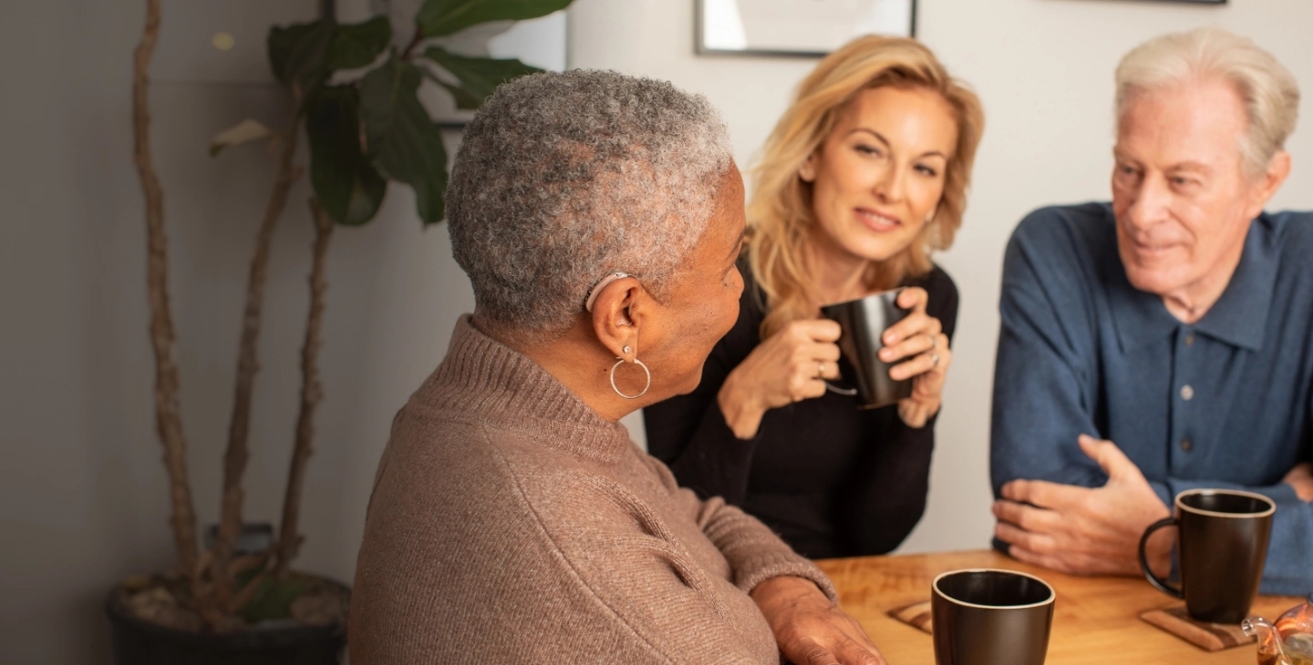 3 People smiling enjoying coffee