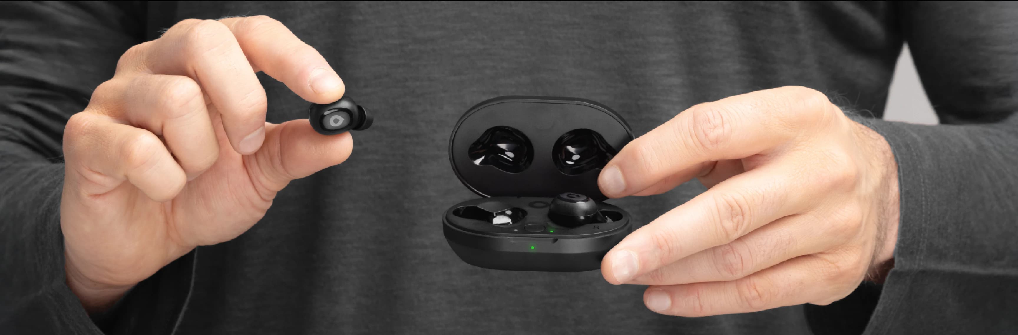 Hands holding Lexie H1 hearing buds