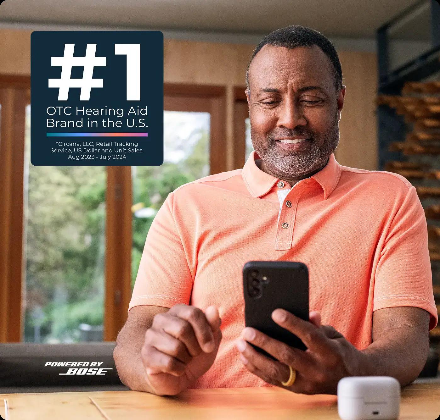 Hero image of a man smiling at a phone