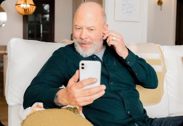 Man on couch with phone