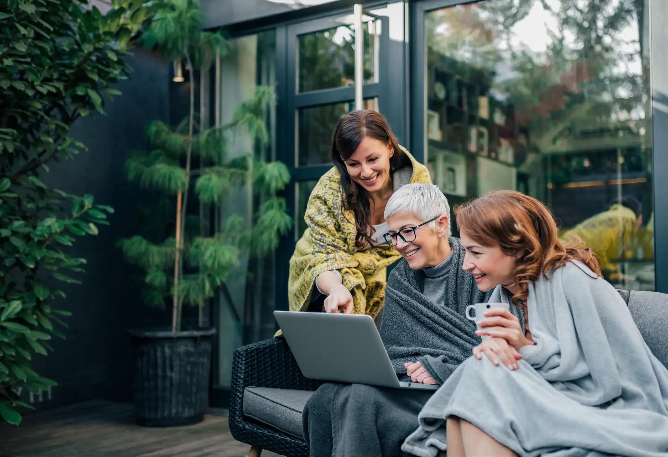 3 women looking at laptop