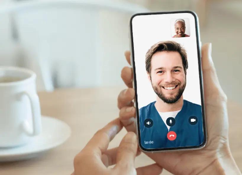 Hand holding a phone speaking with a Lexie Expert over video call.