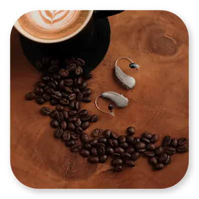 Lexie B1 Lifestyle | Hearing aids lying on a coffee table thumbnail