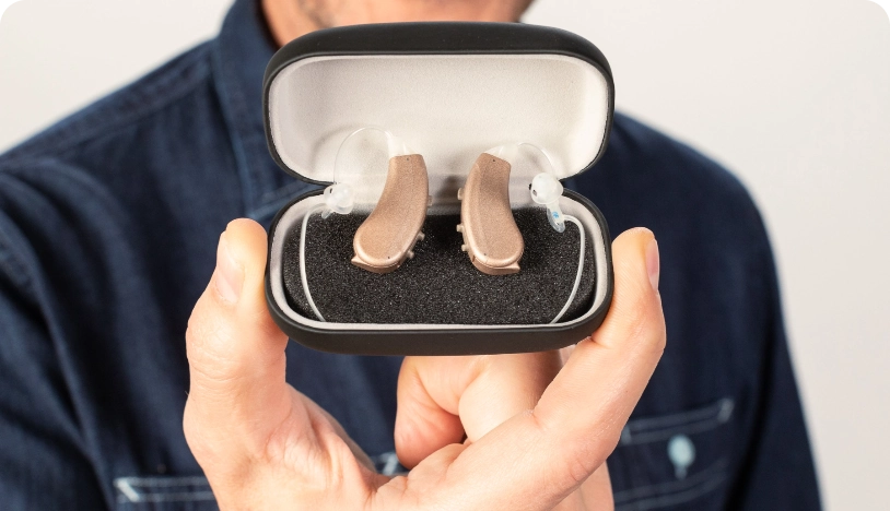 Image of Lexie Lumen hearing aids being shown in their charging case