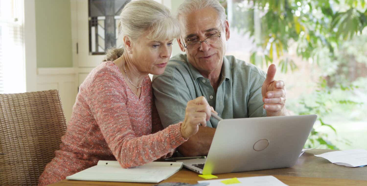 Senior couple researching how to extend their hearing aids' battery life