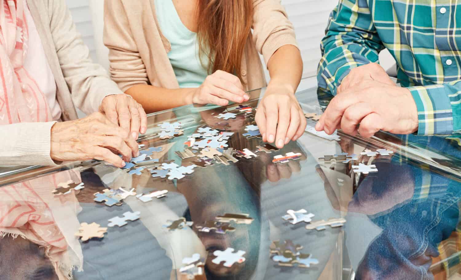 Three people working on a puzzle together
