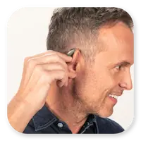 Lexie Lumen Lifestyle | Side profile of a man inserting his Lexie Lumen hearing aids thumbnail.